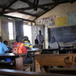 
              A teacher instructs a primary school class at Madudu Catholic Church school, where many students have stayed away due to the risk of Ebola, in Madudu, the subcounty that's been hardest hit by the new Ebola outbreak, near Mubende, in Uganda, Wednesday, Sept. 28, 2022. In this remote Ugandan community facing its first Ebola outbreak, testing trouble has added to the challenges with symptoms of the Sudan strain of Ebola now circulating being similar to malaria, underscoring the pitfalls health workers face in their response. (AP Photo/Hajarah Nalwadda)
            