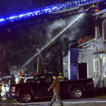 
              Firefighters work to extinguish a fire in a building after a single-engine plane crashed nearby in Keene, N.H., Friday, Oct. 21, 2022. Police at the time could not confirm if the plane crashed into the building. (Kristopher Radder/The Brattleboro Reformer via AP)
            