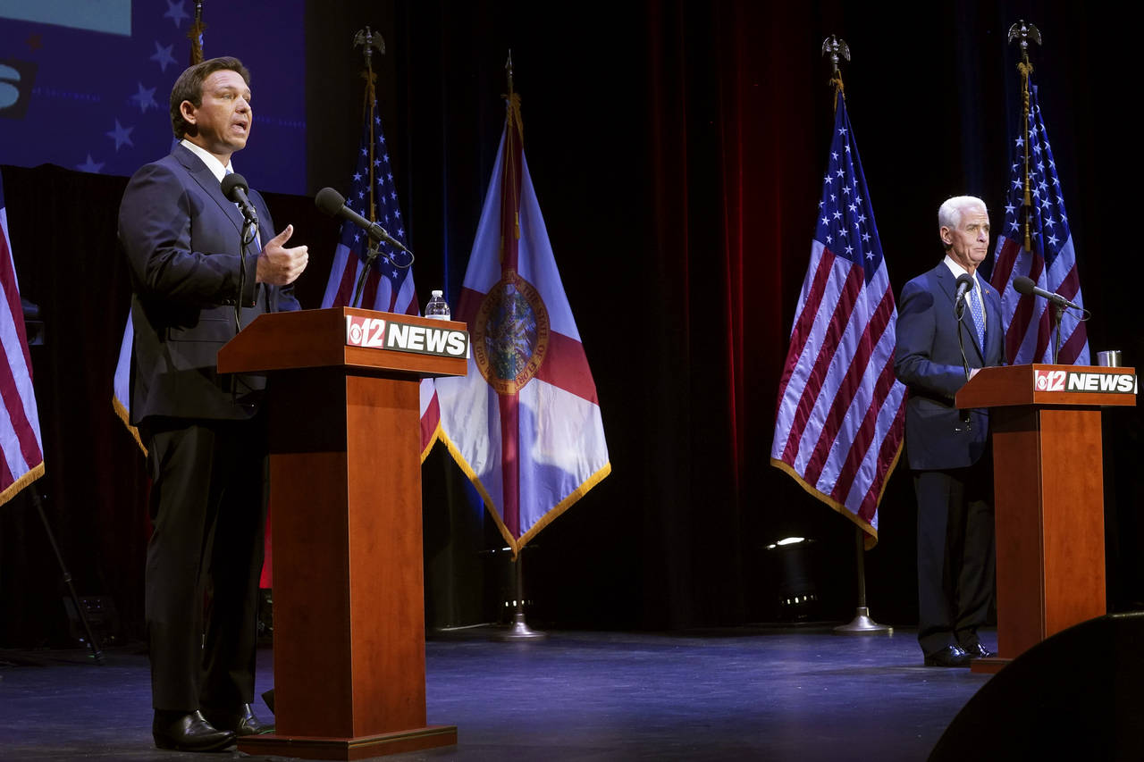 Florida's Republican Gov. Ron DeSantis, left, speaks during a debate with his Democratic opponent C...