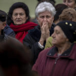 
              People queue to receive a daily ration of bread in a school in Mykolaiv, Tuesday, Oct. 25, 2022. Mykolaiv residents pick up bread from the only food distribution point in Varvarivka, a Mykolaiv district where thousands of people live. One person is allowed to receive free bread just once in three days. (AP Photo/Emilio Morenatti)
            