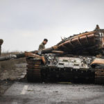 
              Ukrainian soldiers inspect a damaged Russian tank on a road near the recently retaken village of Kamianka, Kharkiv region, Ukraine, Sunday, Oct. 30, 2022.(AP Photo/Efrem Lukatsky)
            