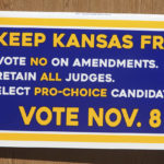 
              This photo shows a sign for a new Kansas group, Keep Kansas Free, seeking to push voters who support abortion rights to go to the polls, on a podium for a news conference, Thursday, Oct. 13, 2022, outside the statehouse in Topeka, Kan. The group wants voters to oppose constitutional changes on the ballot, retain Kansas Supreme Court justices and other judges on the bench and elect candidates who support abortion rights, arguing that all three will protect abortion access. (AP Photo/John Hanna)
            