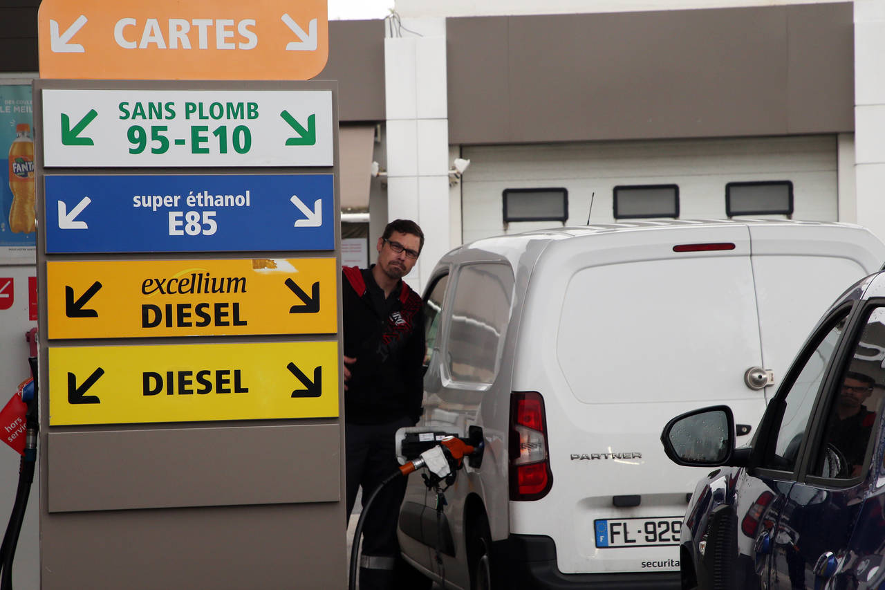 A man fills his tank with petrol in a gas station in Bayonne, southwestern France, Tuesday, Oct.11,...