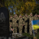 
              Soldiers salute as the Ukrainian national anthem is played at the funeral of Colonel Oleksiy Telizhenko in Bucha, near in Kyiv, Ukraine, Tuesday, Oct. 18, 2022. In March, Colonel Oleksiy was abducted by Russian soldiers from his home in Bucha, six months later his body was found with signals of torture buried in a forest not far away from his village. (AP Photo/Emilio Morenatti)
            