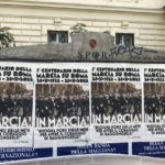 
              Posters commemorating the 100th anniversary of the March on Rome bearing a picture of Italian Fascist Dictator Benito Mussolini reading: "Marching!" with a quote by Mussolini "you have to set yourself goals to have the courage to reach them" are posted on the Rome's public billboard space, Thursday, Oct. 27, 2022. (AP Photo/Gregorio Borgia)
            