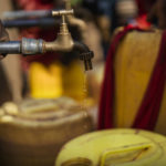 
              Water dribbles out of a faucet at a camp for displaced people on the outskirts of Dollow, Somalia, on Tuesday, Sept. 20, 2022. Somalia is in the midst of the worst drought anyone there can remember. A rare famine declaration could be made within weeks. Climate change and fallout from the war in Ukraine are in part to blame. (AP Photo/Jerome Delay)
            