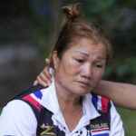 
              Oy Yodkhao, 51, is consoled by a relative after seeing the body of her 4 year old grandson and collapsing inside Wat Rat Samkee temple near the scene of the attack in the rural town of Uthai Sawan, north eastern Thailand, early Friday, Oct. 7, 2022. A former police officer burst into a day care center in northeastern Thailand on Thursday, killing dozens of preschoolers and teachers before shooting more people as he fled. (AP Photo/Sakchai Lalit)
            