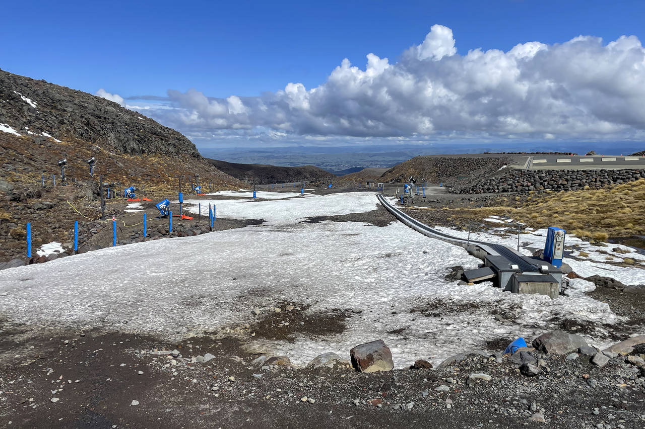 FILE - The learners' slope is almost devoid of snow at the Tūroa ski field on Mt. Ruapehu, New Zea...