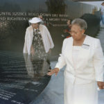 
              FILE - Mamie Till-Mobley, mother of lynching victim Emmett Till, right, and Wilma Allen of New Orleans search for their relatives' names on the black granite table at the Civil Rights Memorial in Montgomery, Ala., Nov. 5, 1989. The memorial is located at the Southern Poverty Law Center. (AP Photo/Dave Martin, File)
            