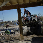 
              A contractor straightens a support post at Getaway Marina, as owner Robert Leisure begins the long process of rebuilding his business after the passage of Hurricane Ian, on San Carlos Boulevard in Fort Myers Beach, Fla., Sunday, Oct. 2, 2022. (AP Photo/Rebecca Blackwell)
            