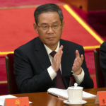 
              Li Qiang, the Communist Party Secretary of Shanghai, applauds during the opening ceremony of the 20th National Congress of China's ruling Communist Party at the Great Hall of the People in Beijing, China, Sunday, Oct. 16, 2022. While Xi Jinping is primed to receive a third five-year term as head of China's ruling Communist Party at this week's congress, new members of the party's leading bodies are expected to be appointed at the meeting, whose proceedings are mainly held behind closed doors. (AP Photo/Mark Schiefelbein)
            