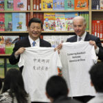 
              FILE - Then Chinese Vice President Xi Jinping, left, and then U.S. Vice President Joe Biden hold t-shirts given to them by students during their visit to the International Studies Learning Center in South Gate, Calif. Feb. 17, 2012. When Xi Jinping came to power in 2012, it wasn't clear what kind of leader he would be. His low-key persona during a steady rise through the ranks of the Communist Party gave no hint that he would evolve into one of modern China's most dominant leaders, or that he would put the economically and militarily ascendant country on a collision course with the U.S.-led international order. (AP Photo/Damian Dovarganes, File)
            