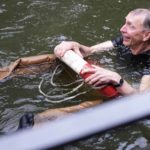 
              Swedish scientist Svante Paabo swims in a pool after his colleagues threw him in, at the Max Planck Institute for Evolutionary Anthropology in Leipzig, Germany, Monday, Oct. 3, 2022. Swedish scientist Svante Paabo was awarded the 2022 Nobel Prize in Physiology or Medicine for his discoveries on human evolution. (AP Photo/Matthias Schrader)
            