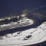 
              In this aerial photo made in a flight provided by mediccorps.org, damage from Hurricane Ian is seen on the causeway leading to Sanibel Island, making it impassable, in St. James City, Fla., on Pine Island, Friday, Sept. 30, 2022. (AP Photo/Gerald Herbert)
            
