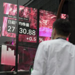 
              A person stands in front of an electronic stock board showing Japan's Nikkei 225 index  Wednesday, Oct. 5, 2022, in Tokyo. Hong Kong’s share benchmark soared more than 5% on Wednesday as Asian shares tracked gains on Wall Street. (AP Photo/Eugene Hoshiko)
            