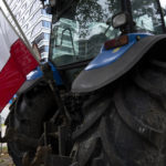
              The Dutch flag flies upside down from a tractor during a small protest outside parliament, where Johan Remkes, an independent mediator, delivered his report into the Dutch government's plans to drastically reduce emissions of nitrogen pollutants by the country's agricultural sector during a press conference in The Hague, Netherlands, Wednesday, Oct. 5, 2022. The plans have sparked nationwide protests by angry farmers who fear for their livelihoods. (AP Photo/Peter Dejong)
            