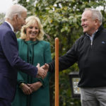 
              President Joe Biden shakes hands with Dale Haney, the chief White House groundskeeper, right, during a tree planting ceremony on the South Lawn of the White House, Monday, Oct. 24, 2022, in Washington. First lady Jill Biden looks on at center. The Bidens recognized Haney who as of this month has tended the lawns and gardens of the White House for 50 years. (AP Photo/Evan Vucci)
            