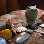 
              Painted rocks and objects to remember lost ones are laid out at a quiet space in the Selah Carefarm in Cornville, Ariz., Oct. 4, 2022. (AP Photo/Dario Lopez-Mills)
            