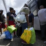 
              Venezuelan migrants board a bus to the Tocumen International Airport to return to Venezuela, in Panama City, Wednesday, Oct. 26, 2022. (AP Photo/Arnulfo Franco)
            
