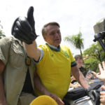 
              Brazil's President Jair Bolsonaro flashes a thumbs up as he greets supporters during a campaign rally in Praca da Liberdade or Liberty Square, in Belo Horizonte, Brazil, Saturday, Oct. 29, 2022. Bolsonaro is facing former President Luiz Inacio Lula da Silva in a runoff election set for Oct. 30. (AP Photo/Yuri Laurindo)
            