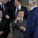 
              France's President Emmanuel Macron, center, gestures to Albania's Prime Minister Edi Rama, second right, at a group photo during a meeting of the European Political Community at Prague Castle in Prague, Czech Republic, Thursday, Oct 6, 2022. Leaders from around 44 countries are gathering Thursday to launch a "European Political Community" aimed at boosting security and economic prosperity across the continent, with Russia the one major European power not invited. (AP Photo/Alastair Grant, Pool)
            