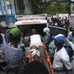 
              A protester who was shot by the police in the leg is moved to an ambulance during a protest demanding the resignation of prime Minister Ariel Henry in the Petion-Ville area of Port-au-Prince, Haiti, Monday, Oct. 3, 2022. (AP Photo/Odelyn Joseph)
            
