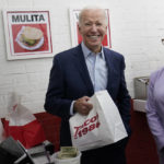 
              FILE - President Joe Biden, joined by Rep. Karen Bass, D, Calif., looks to members of the media after paying for a takeout order at Tacos 1986, a Mexican restaurant, in Los Angeles, Thursday, Oct. 13, 2022. (AP Photo/Carolyn Kaster, File)
            