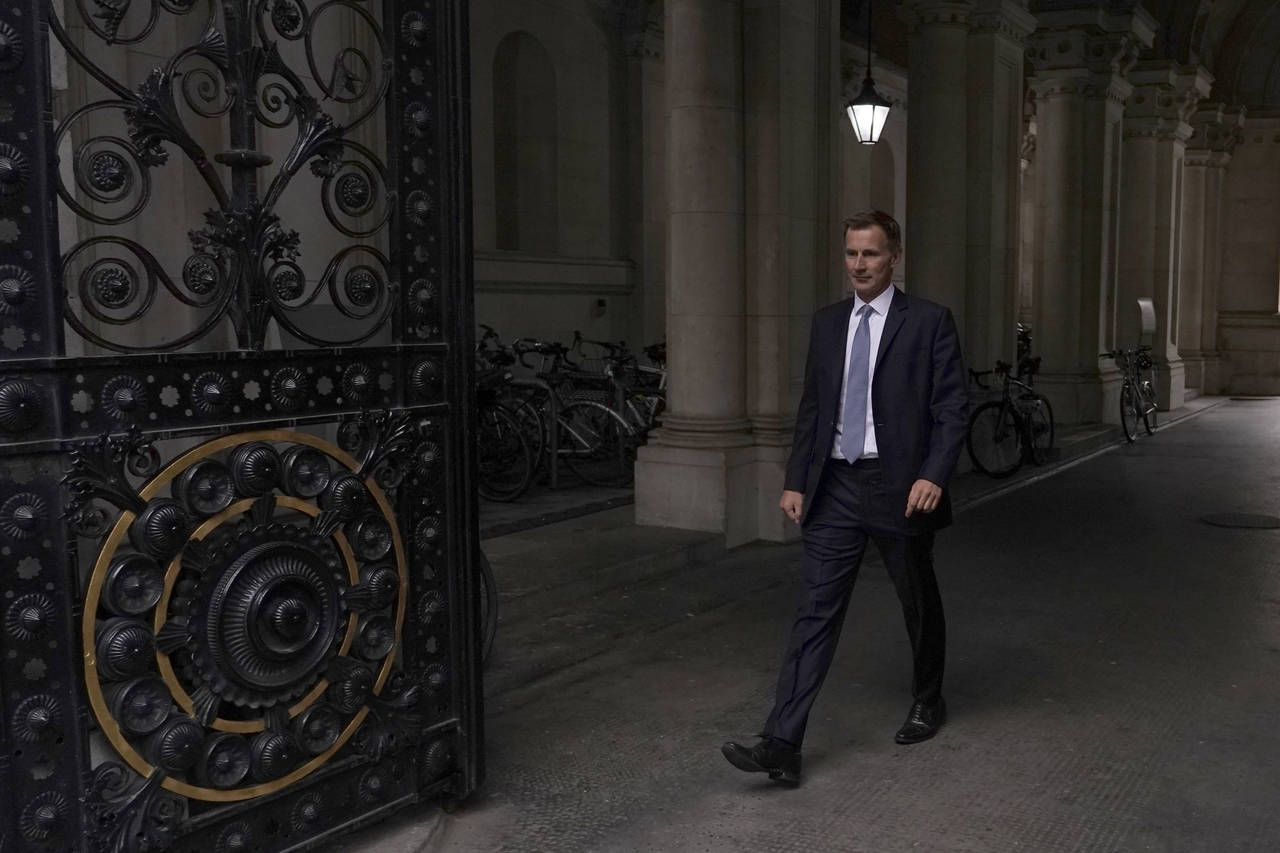 Britain's new Treasury Chief Jeremy Hunt walks into Downing Street to see the Prime Minister Liz Tr...