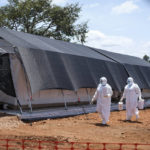 
              Doctors walk inside the Ebola isolation section of Mubende Regional Referral Hospital, in Mubende, Uganda, Thursday, Sept. 29, 2022. In this remote Ugandan community facing its first Ebola outbreak, testing trouble has added to the challenges with symptoms of the Sudan strain of Ebola now circulating being similar to malaria, underscoring the pitfalls health workers face in their response. (AP Photo/Hajarah Nalwadda)
            