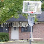 
              A basketball goal stands on the street in front of the house in the 400 block of South Hickory Avenue where eight people died in an apparent murder-suicide involving two adults and six children, Friday, Oct. 28, 2022, in Broken Arrow, Okla. Emergency personnel responded to the house Thursday for a reported fire. The children ranged in age from 1 to 13 years-old. (Mike Simons/Tulsa World via AP)
            