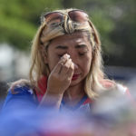 
              A woman weeps as she offers prayer outside Kanjuruhan Stadium where a soccer stampede killed more than 100 people on Saturday, in Malang, East Java, Indonesia, Tuesday, Oct. 4, 2022. An Indonesian police chief and nine elite officers were removed from their posts Monday and 18 others were being investigated for responsibility in the firing of tear gas inside a soccer stadium that set off a stampede, officials said. (AP Photo/Dicky Bisinglasi)
            