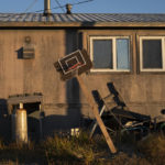 
              A homemade basketball hoop stands tilted outside a home in Shishmaref, Alaska, Saturday, Oct. 1, 2022. (AP Photo/Jae C. Hong)
            