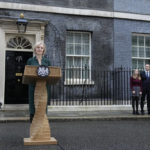 
              Outgoing British Prime Minister Liz Truss, left, speaks outside Downing Street in London, Tuesday, Oct. 25, 2022. Former Treasury chief Rishi Sunak is set to become Britain's first prime minister of color after being chosen Monday to lead a governing Conservative Party desperate for a safe pair of hands to guide the country through economic and political turbulence. (AP Photo/Frank Augstein)
            