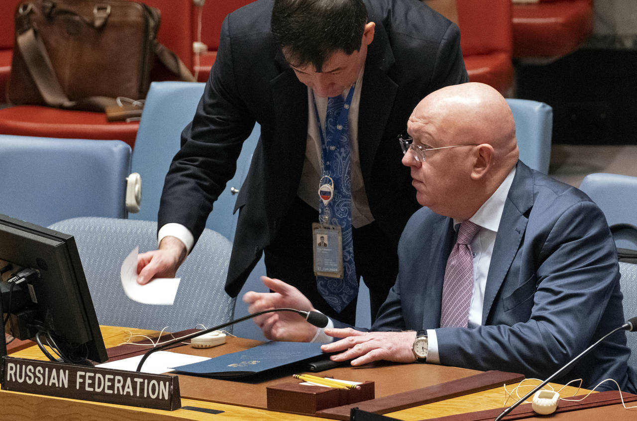 Russian Ambassador to the United Nations Vasily Nebenzya, seated, speaks with Dmitry Polyanskiy, Fi...