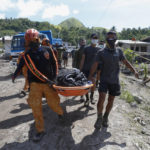 
              Rescuers carry a body at Maguindanao's Datu Odin Sinsuat town, southern Philippines on Sunday Oct. 30, 2022. Victims of a huge mudslide set off by Tropical Storm Nalgae in a coastal Philippine village that had once been devastated by a killer tsunami mistakenly thought a tidal wave was coming and ran to higher ground toward a mountain and were buried alive, an official said Sunday. (AP Photo)
            