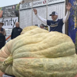 
              Travis Gienger from Anoka, Minn., stands behind his winning pumpkin at the 49th World Championship Pumpkin Weigh-Off in Half Moon Bay, Calif., Monday, Oct. 10, 2022. AP Photo/Haven Daley)
            