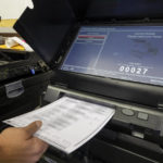 
              FILE - Torrance County administrative assistant clerk Kevin Pham introduces a ballot in a counting machine during a testing of election equipment with local candidates and partisan officers in Estancia, N.M., Sept. 29, 2022. Unlike in many other countries, elections in the U.S. are highly decentralized, complex and feature a long list of races on the ballot, from president or Congress all the way down to local ballot measures or town council seats. Rules also vary greatly by state. (AP Photo/Andres Leighton, File)
            