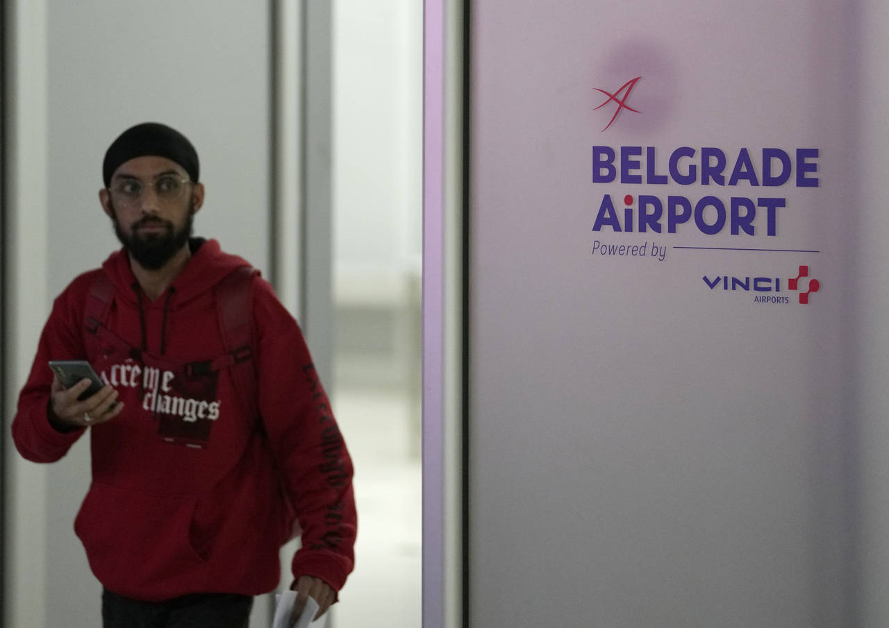 A passenger from a flight from Turkey arrives at Belgrade Nikola Tesla Airport, in Serbia, Tuesday,...