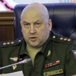 
              FILE - Colonel General Sergei Surovikin, Commander of the Russian forces in Syria, speaks, with a map of Syria projected on the screen in the back, at a briefing in the Russian Defense Ministry in Moscow, Russia, June 9, 2017. Surovikin has become the face of Russia’s new strategy in Ukraine, which includes unleashing a barrage of strikes against the country's infrastructure. (AP Photo/Pavel Golovkin, File)
            