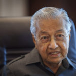 
              FILE - Malaysia's former Prime Minister Mahathir Mohamad speaks during an interview with The Associated Press at his office in Kuala Lumpur, Malaysia, Friday, Aug. 19, 2022. Mahathir announced Tuesday, Oct. 11, 2022, he will contest in general elections expected next month, and warned that a win by the ruling Malay party could see imprisoned ex-Prime Minister Najib Razak pardoned and let off the hook. (AP Photo/Vincent Thian, File)
            