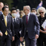 
              Japan's Prime Minister Fumio Kishida, front left, walks with Australian Prime Minister Anthony Albanese, front right, during a visit to Kings Park in Perth, Australia, Saturday, Oct. 22, 2022. Kishida visit is to bolster military and energy cooperation between Australia and Japan amid their shared concerns about China. (Stefan Gosatti/Pool Photo via AP)
            