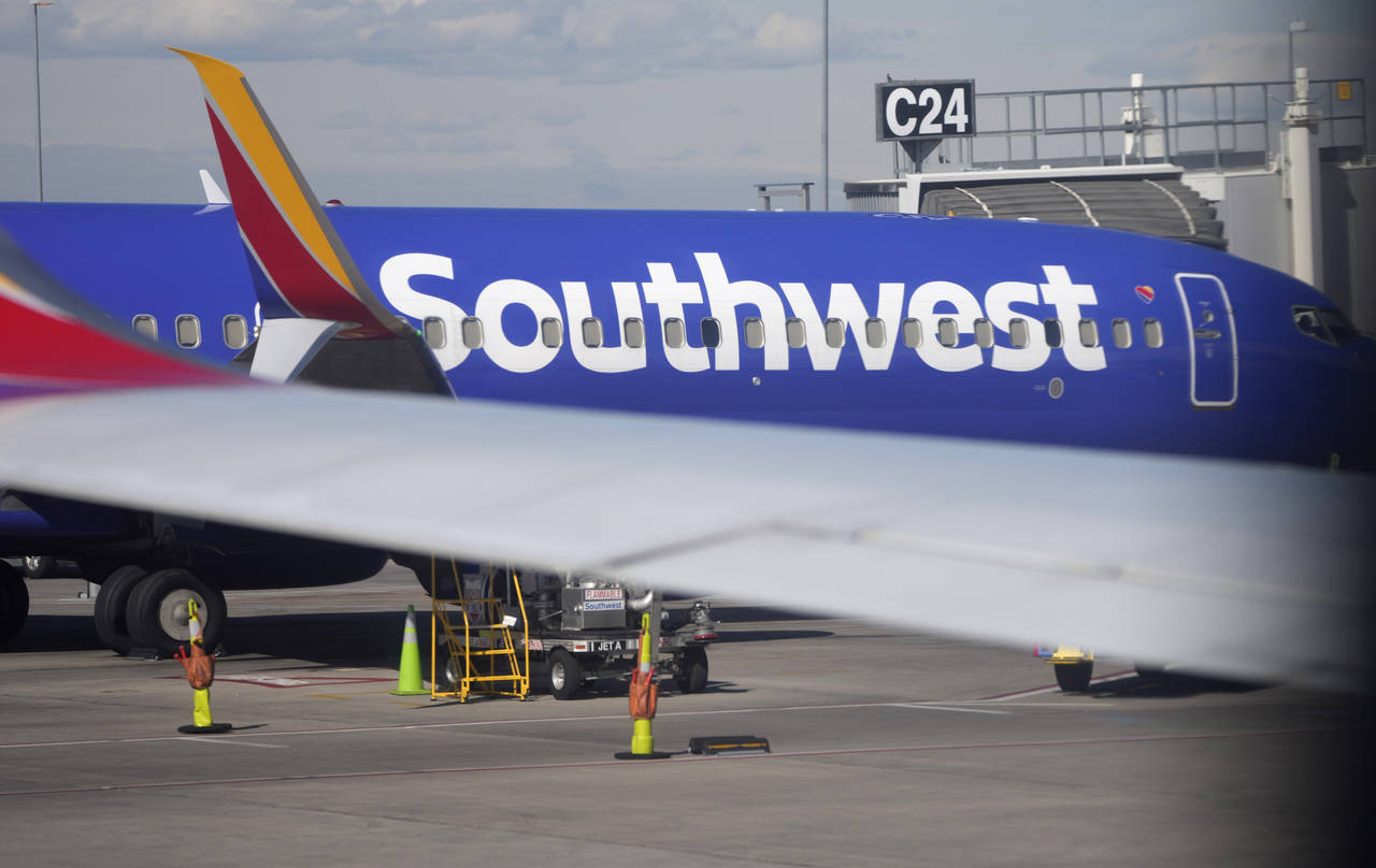 FILE - A Southwest Airlines jetliner sits at a gate on the C concourse of Denver International Airp...