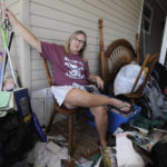 
              Brenda Palmer is surrounded by belongings from her mobile home, which filled with floodwaters from Hurricane Ian, in Fort Myers, Fla., on Sunday, Oct. 9, 2022. The power is back on, but Palmer said the hurricane wiped out the residence she shares with her husband Ralph. (AP Photo/Jay Reeves)
            