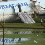 
              A security guard walks beside a damaged Korean Air plane on Monday Oct. 24, 2022 after it overshot the runway at the Mactan-Cebu International Airport in Cebu, central Philippines. The Korean Air plane overshot the runway while landing in bad weather in the central Philippines late Sunday, but authorities said all 173 people on board were safe. (AP Photo/Juan Carlo De Vela)
            