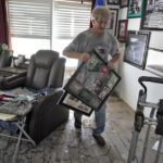 
              Ron Audette removes water soaked memorabilia from his storm-damaged home after Hurricane Ian, Tuesday, Oct. 4, 2022, in North Port, Fla. (AP Photo/Chris O'Meara)
            