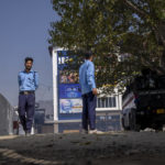
              Security guards stand guard outside Kashmir's first multiplex cinema after it was opened to public in Srinagar, Indian controlled Kashmir, Saturday, Oct. 1, 2022. The multi-screen cinema hall has opened in the main city of Indian-controlled Kashmir for public for the first time in 14 years. The 520-seat hall with three screens opened on Saturday, amid elaborate security but only about a dozen viewers lined up for the first morning show. (AP Photo/Dar Yasin)
            
