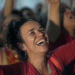 
              Supporters of former Brazilian President Luiz Inacio Lula da Silva react to the announcement that he won Brazil's presidential election, while following the results at a Brazilian cultural association in Lisbon, Sunday evening, Oct. 30, 2022. Twenty years after first winning the Brazilian presidency, the leftist defeated incumbent Jair Bolsonaro Sunday in an extremely tight election that marks an about-face for the country after four years of far-right politics. (AP Photo/Armando Franca)
            