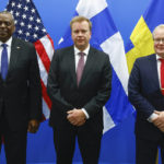 
              U.S. Secretary for Defense Lloyd J. Austin III, left, poses with Finland's Defense Minister Antti Kaikkonen, center, and Sweden's Defense Minister Peter Hultqvist as they meet on the sidelines of a NATO defense ministers meeting at NATO headquarters in Brussels, Thursday, Oct. 13, 2022. NATO Defence Ministers are meeting in Brussels Thursday as the military alliance presses ahead with plans to hold a nuclear exercise next week as concerns deepen over President Vladimir Putin's insistence that he will use any means necessary to defend Russian territory. (Stephanie Lecocq, Pool Photo via AP)
            