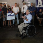 
              Texas Gov. Greg Abbott, center, talks with supporters as he prepares to canvass for votes, Saturday, Oct. 1, 2022, in Harlingen, Texas. As Democrats embark on another October blitz in pursuit of flipping America's biggest red state, Republicans are taking a swing of their own: Making a play for the mostly Hispanic southern border on Nov. 8 after years of writing off the region that is overwhelmingly controlled by Democrats. (AP Photo/Eric Gay)
            