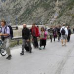
              People walk toward the border crossing between Georgia and Russia at Verkhny Lars, as they leave Chmi, North Ossetia–Alania Republic, Russia, Wednesday, Sept. 28, 2022. Long lines of vehicles have formed at a border crossing between Russia's North Ossetia region and Georgia after Moscow announced a partial military mobilization. (AP Photo)
            
